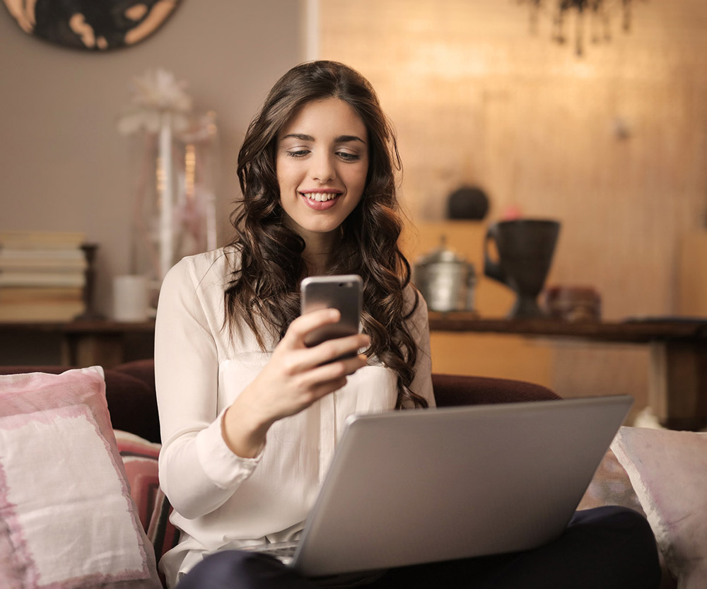 Woman on sofa looking at phone